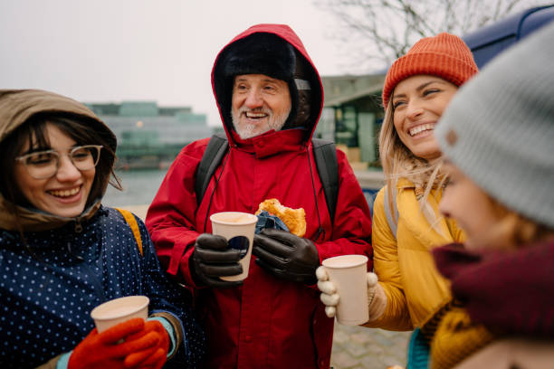 smiling tourists trying out local street food and drinks - white denmark nordic countries winter imagens e fotografias de stock