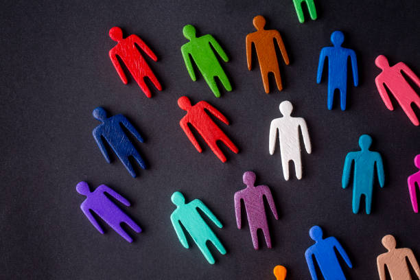 istock Equality and diversity concept. Multi-colored wooden figurines on a blackboard. 1332141770