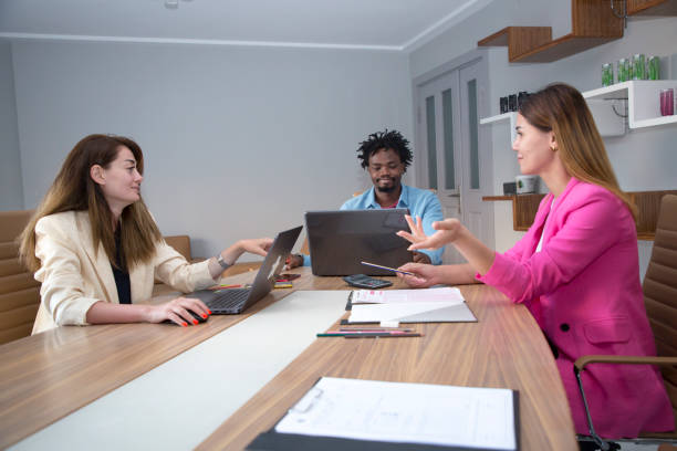 istock Young business colleagues in board room at office 1332142109
