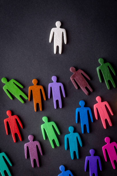 istock Equality and diversity concept. Multi-colored wooden figurines on a blackboard. 1332142433