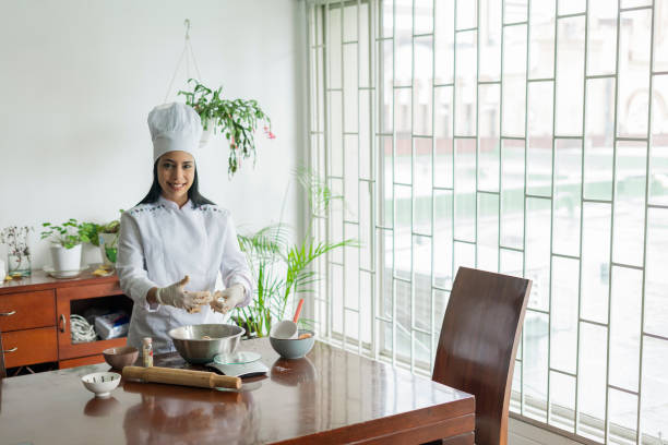 istock Portrait of a beautiful young chef looking at the camera while wearing her uniform and preparing the dessert she wants to finish for her clients 1332143186