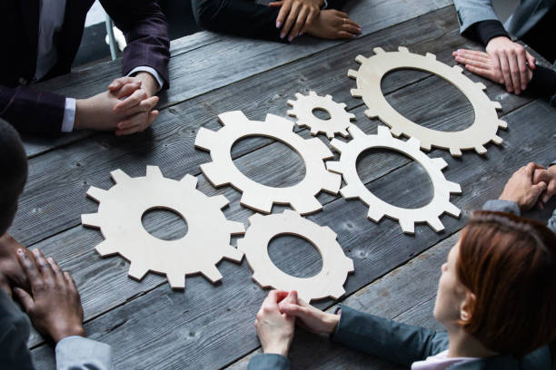 istock People with cogs of business 1332145192