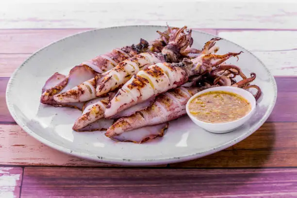 Grilled squid favorite seafood on wooden table background