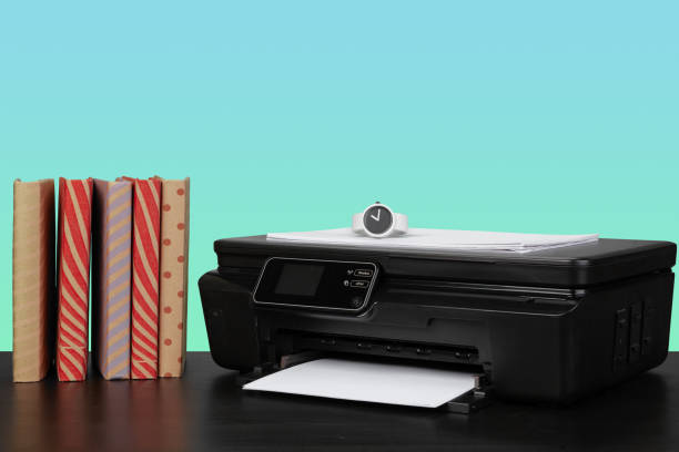 istock Home laser printer on desk against green background 1332147538