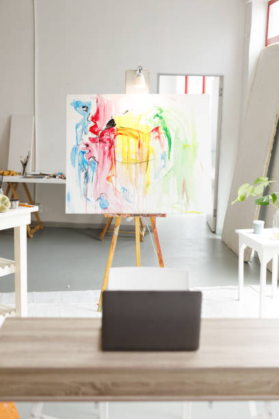 istock Modern abstract oil painting on canvas sitting on easel in artists studio 1332147676