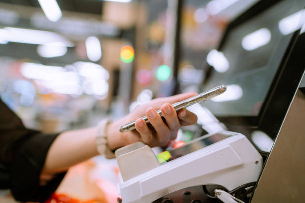 istock Paying with smart phone at department store. 1332148169