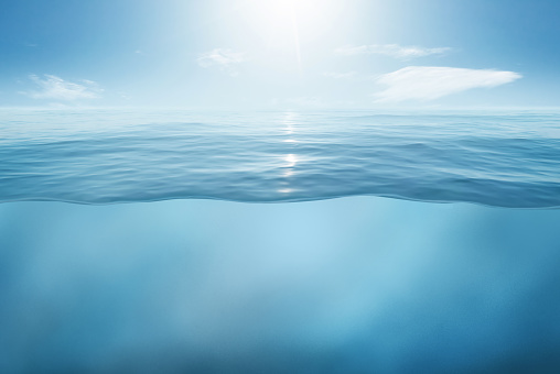 Blue sea or ocean water surface and underwater with sunny and cloudy sky. 3d illustration