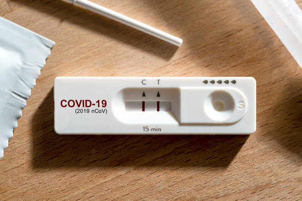 close up positive show result of covid infected show on nasal rapid self test kit at home stock photo