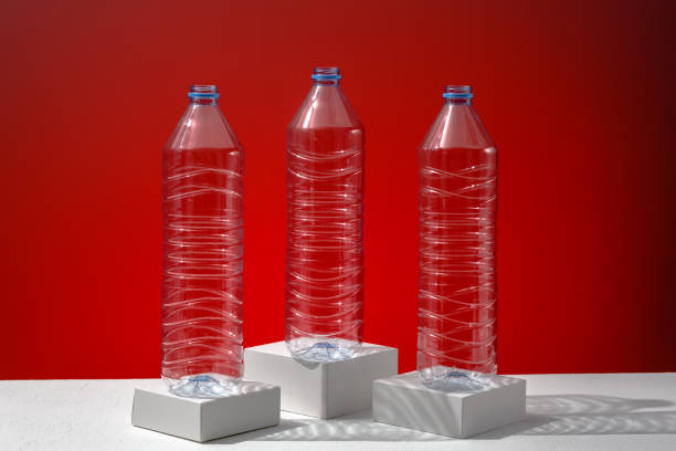 istock Plastic bottles on a red background as a symbol of ecological catastrophes. 1332149327
