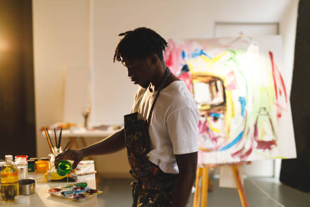 istock African american male painter at work holding paint in art studio 1332150632