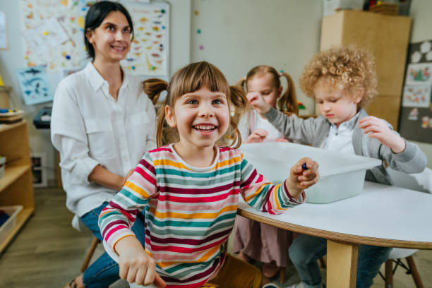 istock Preschool students playing with kinetic sand in kindergarten 1332150806