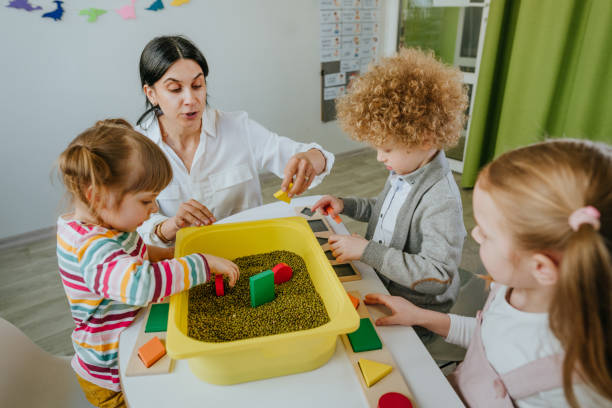 istock Preschool students playing with raw mung beans in kindergarten 1332150890