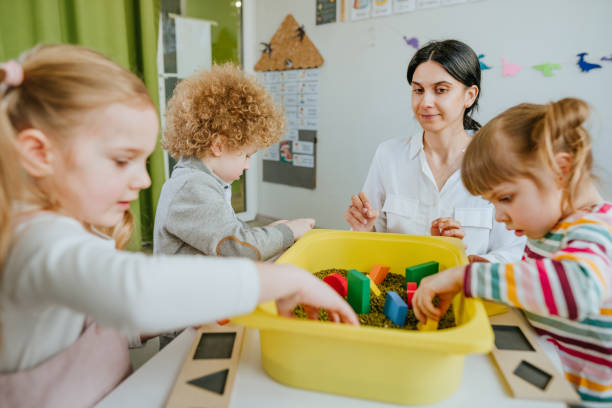istock Preschool students playing with raw mung beans in kindergarten 1332150896