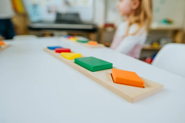 istock Wooden geometric forms on the desk in the kindergarten 1332151008