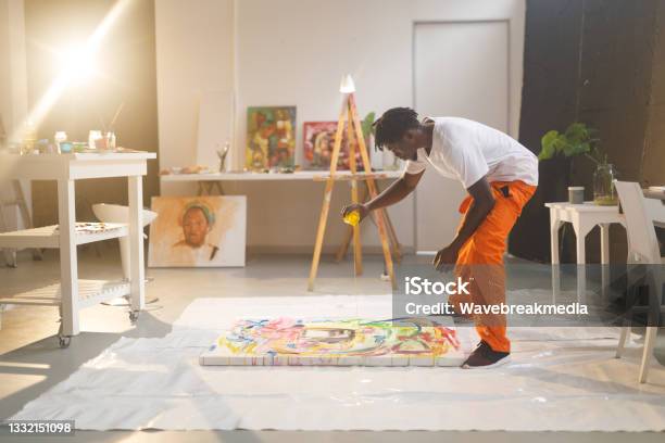 African American Male Painter At Work Painting On Canvas In Art Studio Stock Photo - Download Image Now