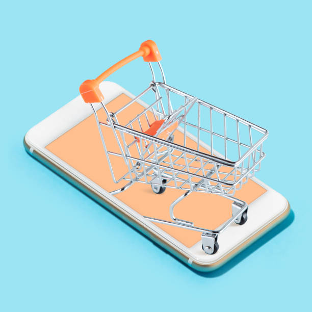istock Creative collage. Supermarket trolley standing on the smartphone screen over light blue background. 1332155574
