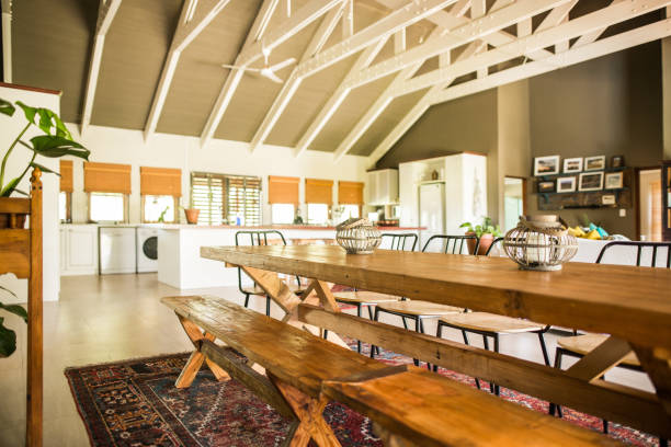 istock Wooden dining table and benches in an open plan home 1332158298