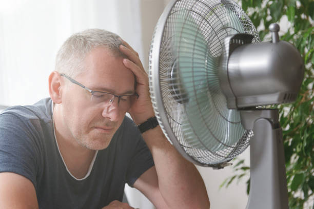 istock Man suffers from heat at home 1332158479
