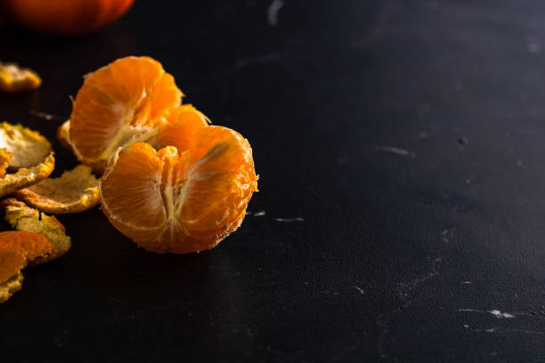 istock Sliced oranges on black background. Fresh fruit isolated on black 1332158936