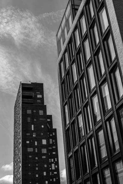 istock Two modern apartment buildings with clouds 1332160044