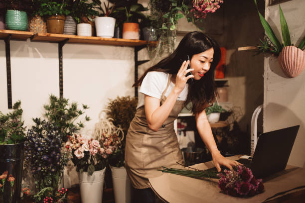 istock Florist taking orders on the phone 1332161561