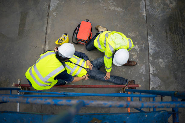 Safety team help employee accident falling scaffolding to the floor. Builder injury accident falling scaffolding to the floor. Basic first aid training for support accident in site work, Safety team help employee accident. Construction Site accident stock pictures, royalty-free photos & images