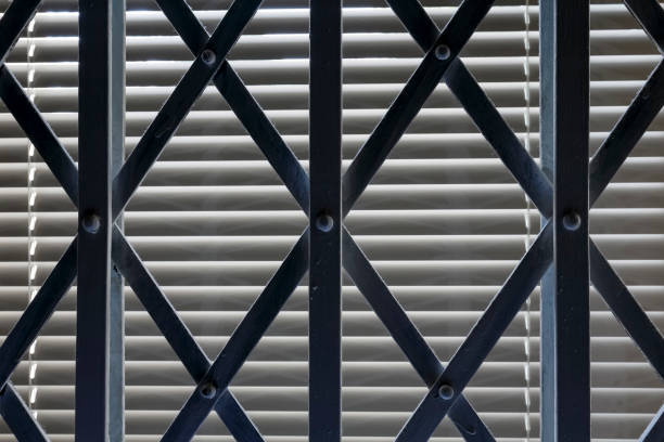 istock Folding steel grille is visible in front of a closed window 1332164078