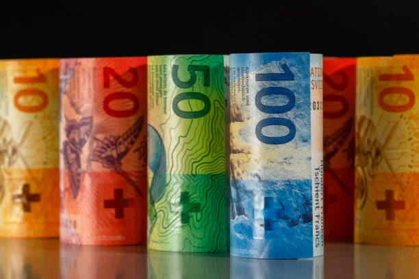 Rolled-up Swiss banknotes The rolls of Swiss money. This is the concept and idea to present the economy. french currency stock pictures, royalty-free photos & images