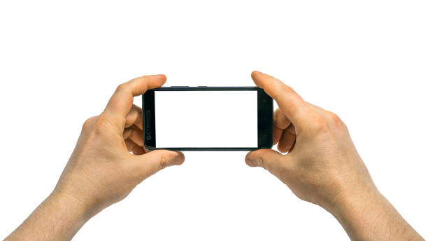 istock Man with left and right hand holding a mobile smartphoneisolated on white background with clipping path for the screen. 1332165451