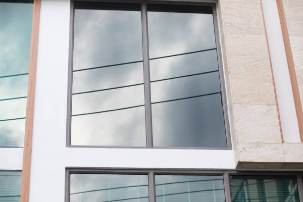 istock Overcast sky reflected in window of modern office building 1332168472