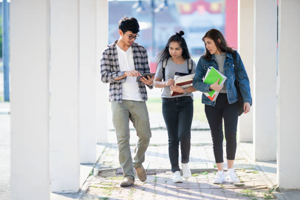 istock Three Asian people, Scholarship Students walking with smile in park at university after learning 1332169133