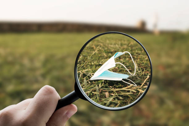 istock Magnifying glass focusing a mask on the ground 1332170491