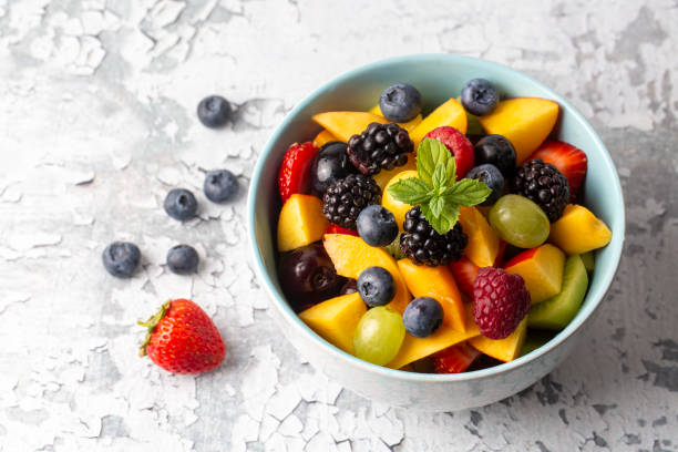 istock Dietary fruit salad with fresh summer fruits 1332170676