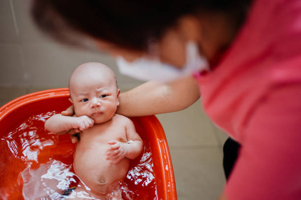 istock Grandmother taking a bath for her grandson in bathroom 1332170917