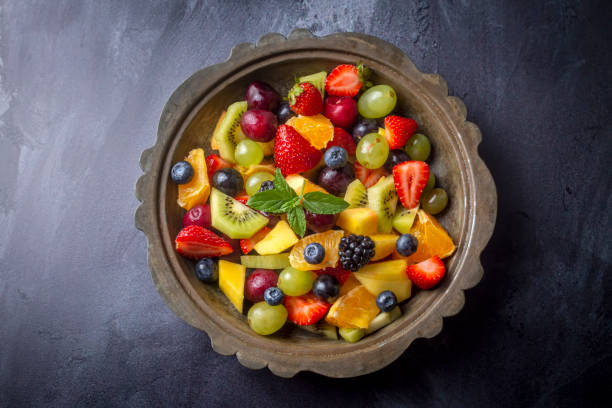 istock Dietary fruit salad with fresh summer fruits 1332171652