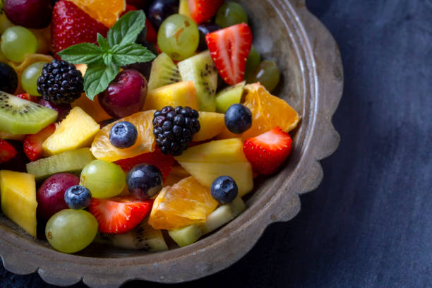 istock Dietary fruit salad with fresh summer fruits 1332172855