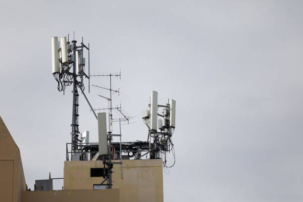 istock Bunch of 4g and 5g antennas on rooftop 1332175237
