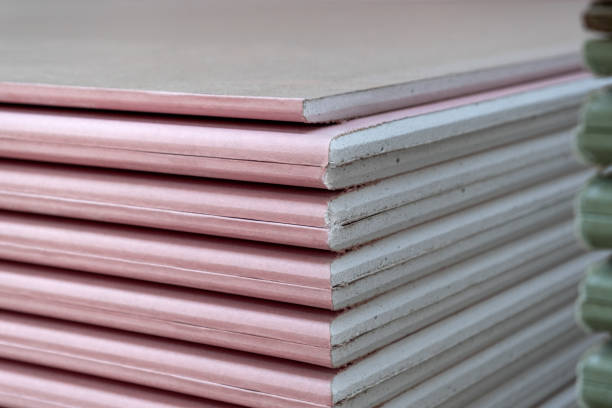 istock Close-up of The stack of Plasterboard fire resistant gypsum board cardboard surface Panel Type DF for indoor concrete walls prepared for construction 1332176116