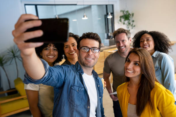 istock Group of creative workers taking a selfie at the office 1332176232