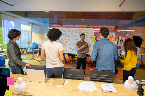 istock Man leading a creative business group while sharing ideas in meeting 1332176237