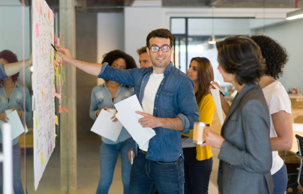 istock Creative man presenting his business strategy to his team in a meeting 1332176294