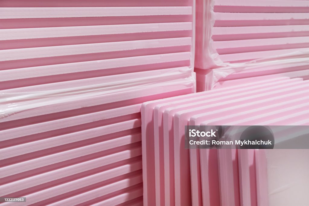 Pink Extruded Polystyrene XPS foam thermal insulation boards  stacked in construction site. High Density, water absorption. Eco energy saving  technology Insulation Stock Photo