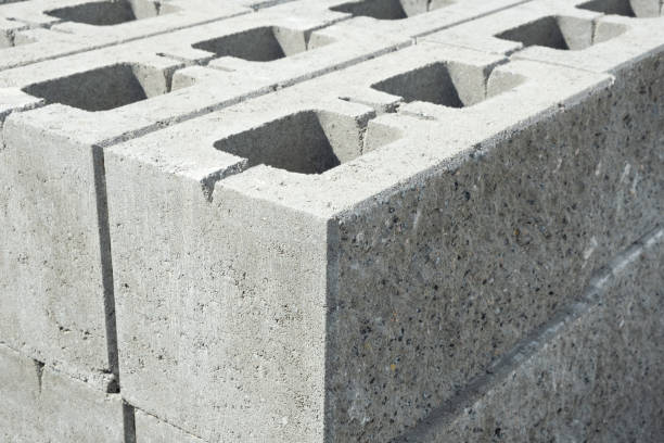 istock Stack of cement concrete Building cinder blocks brick  on pallet in hardware store with decorative stone texture side close up 1332177055