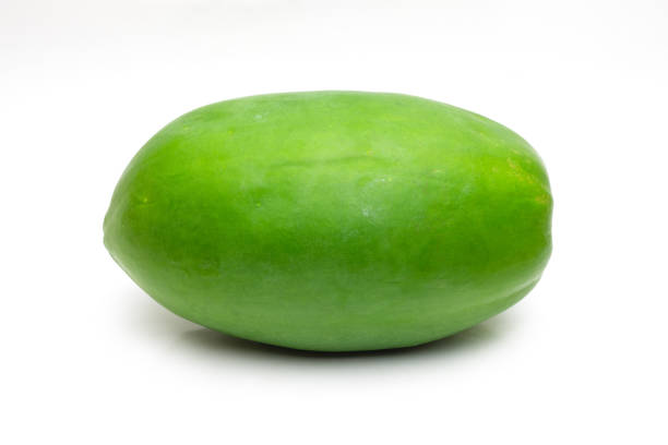 Organic raw green papaya fruit on isolated white background