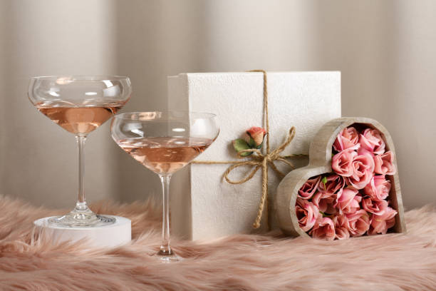 Glasses with rose wine Two glasses with rose wine and decorated gifts heart shape valentines day fur pink stock pictures, royalty-free photos & images