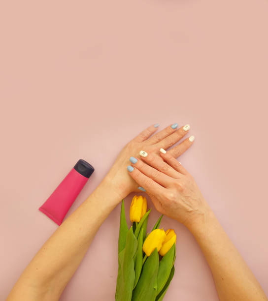 istock female hands cream cosmetic flower tulip 1332182424