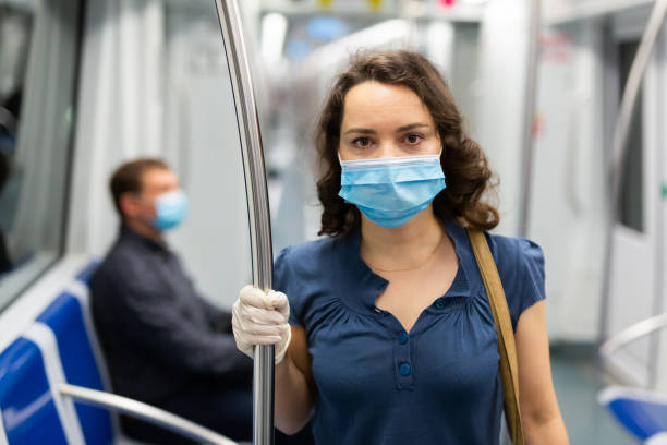 istock Travelers in protective equipment in a subway carriage 1332183113