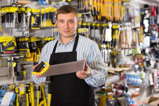 istock Man seller in apron having tools in hands 1332183147