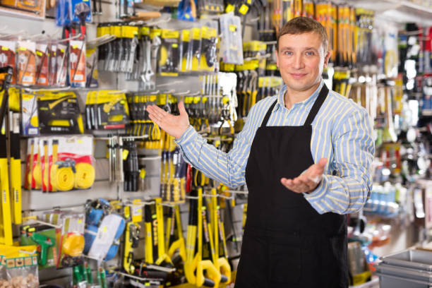 istock Man seller in apron having tools in hands 1332183150
