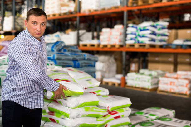 istock Man choosing compost soil in plastic bags in hypermarket 1332183193